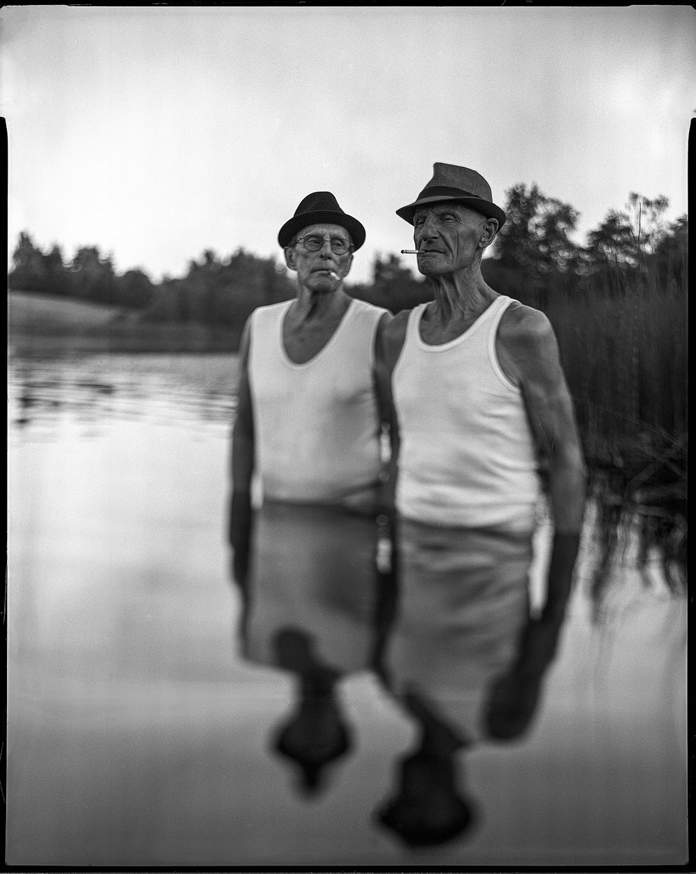Heikki Leis two elder man standing in a lake